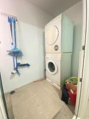 Laundry room with stacked washer and dryer