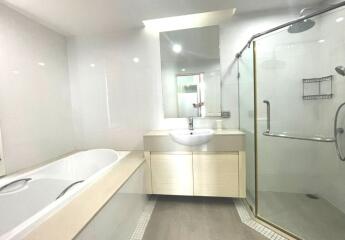 Modern bathroom with bathtub, sink, and glass shower