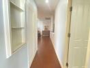 Well-lit hallway with wooden floor