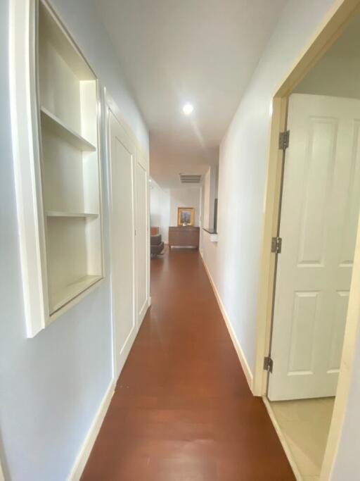 Well-lit hallway with wooden floor