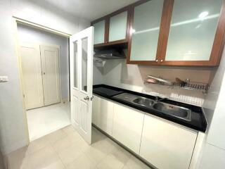 Modern kitchen with white cabinets and double sink