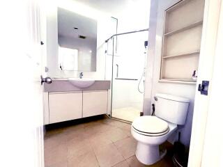 Modern bathroom with vanity, toilet, and shower enclosure