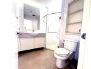 Modern bathroom with vanity, toilet, and shower enclosure