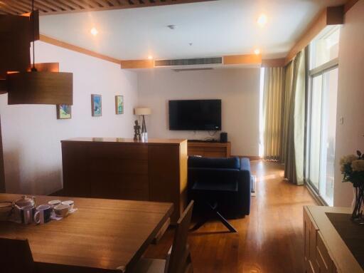 Living room with wooden furniture and wall-mounted TV