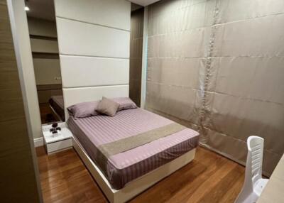 Modern bedroom with wooden flooring and minimalistic design