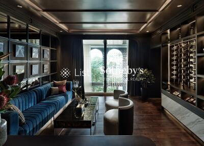 Elegant living room with wall-to-wall shelving, a wine display, and large windows.