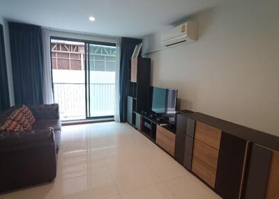 Spacious living room with modern furnishings and large window