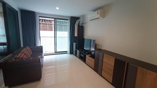 Spacious living room with modern furnishings and large window