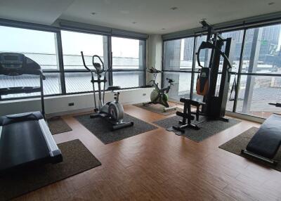 Home gym with workout equipment and large windows