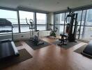 Home gym with workout equipment and large windows