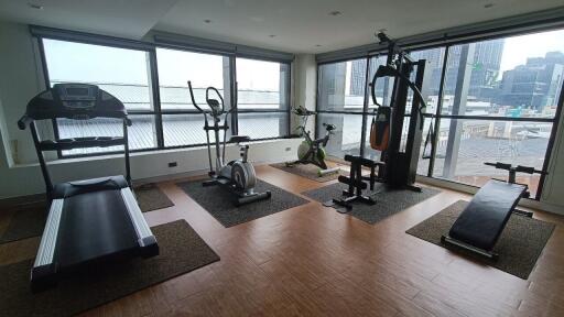 Home gym with workout equipment and large windows