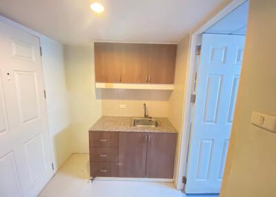 Compact kitchen area with cabinets and sink