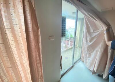 Living room with large patio door leading to a balcony