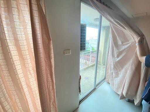 Living room with large patio door leading to a balcony