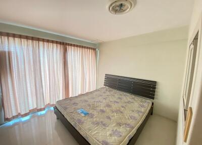 Bedroom with large window and bed