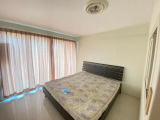 Bedroom with large window and bed