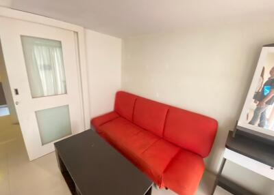 Living area with red sofa and coffee table