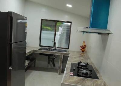 Modern kitchen with stainless steel appliances and large window