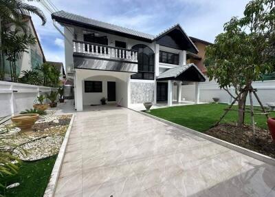 Exterior view of a two-story house with driveway and landscaped yard