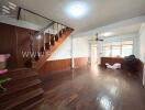 Spacious living room with wooden flooring and a staircase