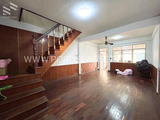 Spacious living room with wooden flooring and a staircase