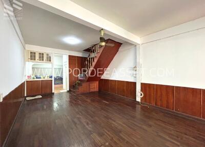 Spacious living room with wooden floor and staircase