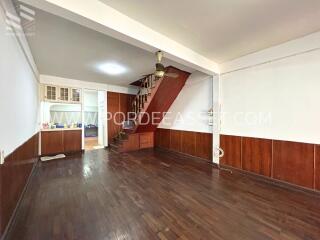 Spacious living room with wooden floor and staircase