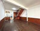 Spacious living room with wooden floor and staircase