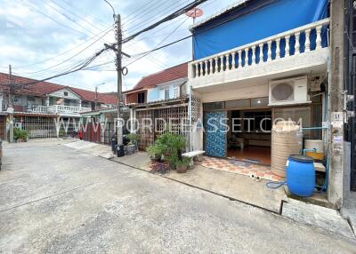 Front view of a townhouse with outdoor space