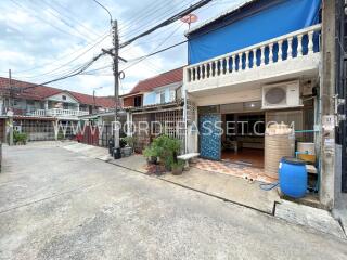 Front view of a townhouse with outdoor space