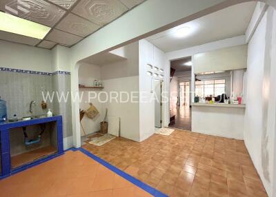 Spacious kitchen area with tiled floor and built-in sink