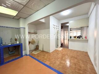 Spacious kitchen area with tiled floor and built-in sink