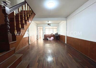 Spacious living room with wooden staircase and flooring