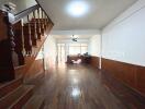 Spacious living room with wooden staircase and flooring