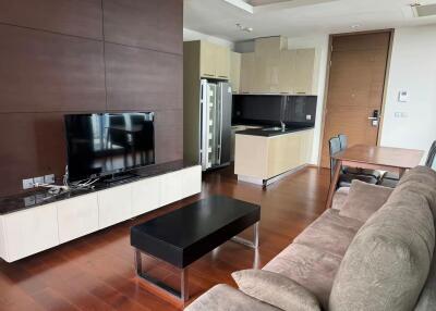 Modern living area with kitchen, TV, and sofa