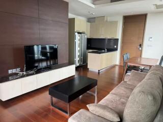 Modern living area with kitchen, TV, and sofa