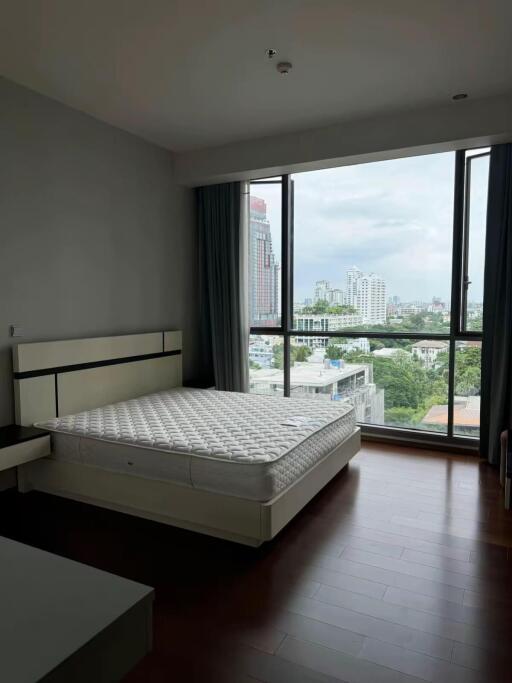 Bedroom with large window and city view