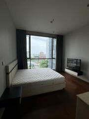 Modern bedroom with large window and city view