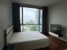 Modern bedroom with large window and city view