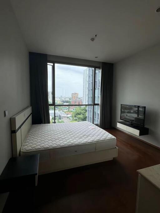 Modern bedroom with large window and city view