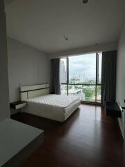 Modern bedroom with large window and city view