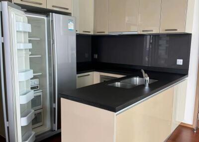 Modern kitchen with beige cabinets and stainless steel appliances