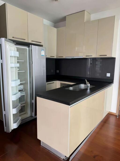 Modern kitchen with beige cabinets and stainless steel appliances