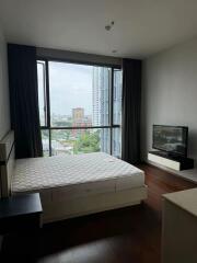 Bedroom with a large window offering city views