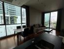 Modern living room with dining area and large windows