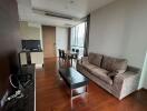 Spacious living area with sofa, coffee table, dining table, and kitchenette