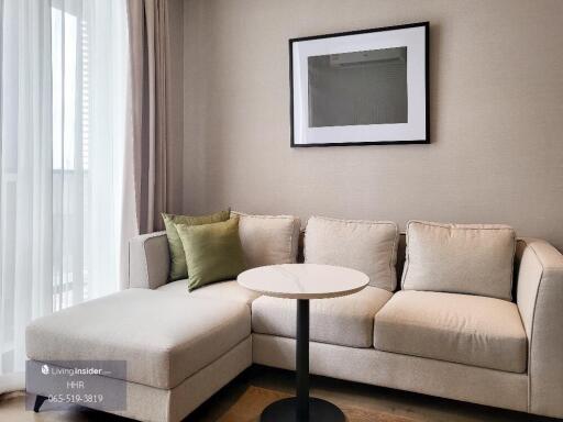 Cozy living room with a beige corner sofa and a small round table