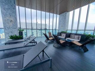 Outdoor lounge area with seating and city views