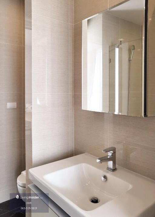 Modern bathroom with sink, mirror, and shower area