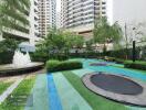 Outdoor recreational area with trampolines and a fountain